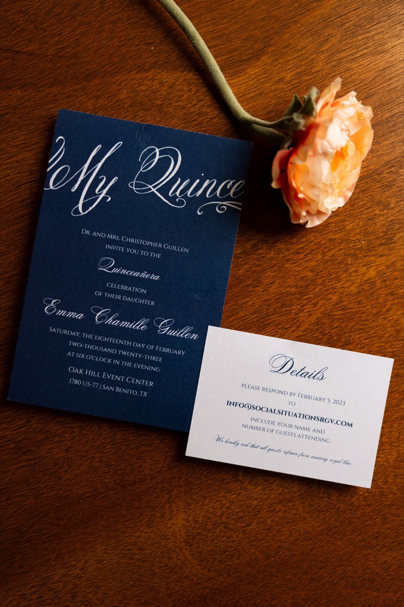 Navy quinceañera invitation with white script and matching details card