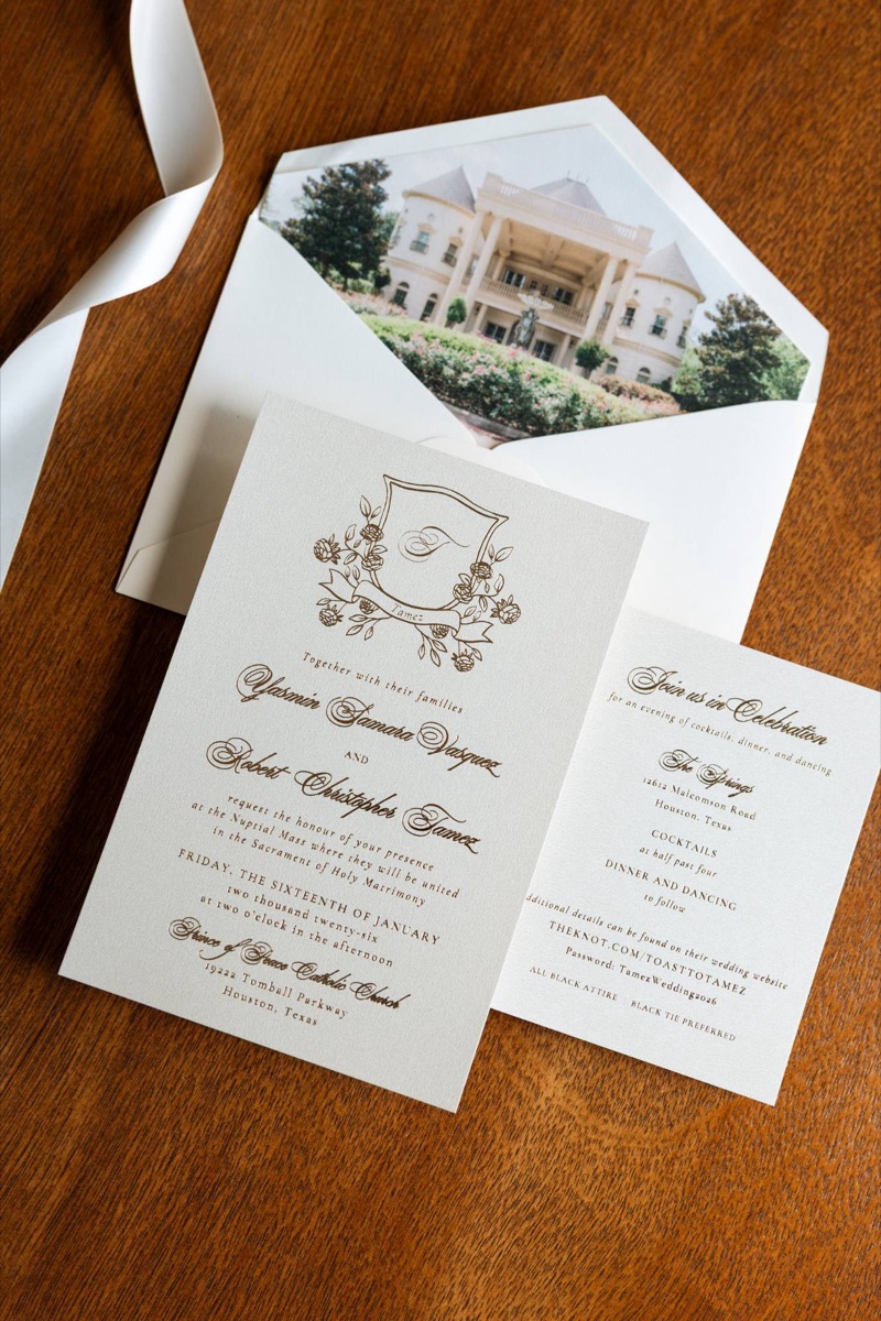 Invitation suite with gold details on a wooden table