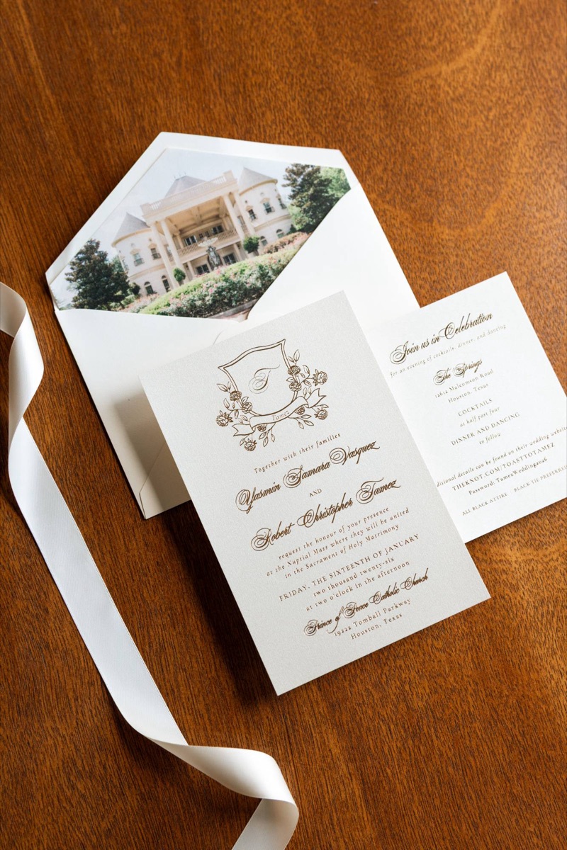 Invitation suite with gold details on a wooden table