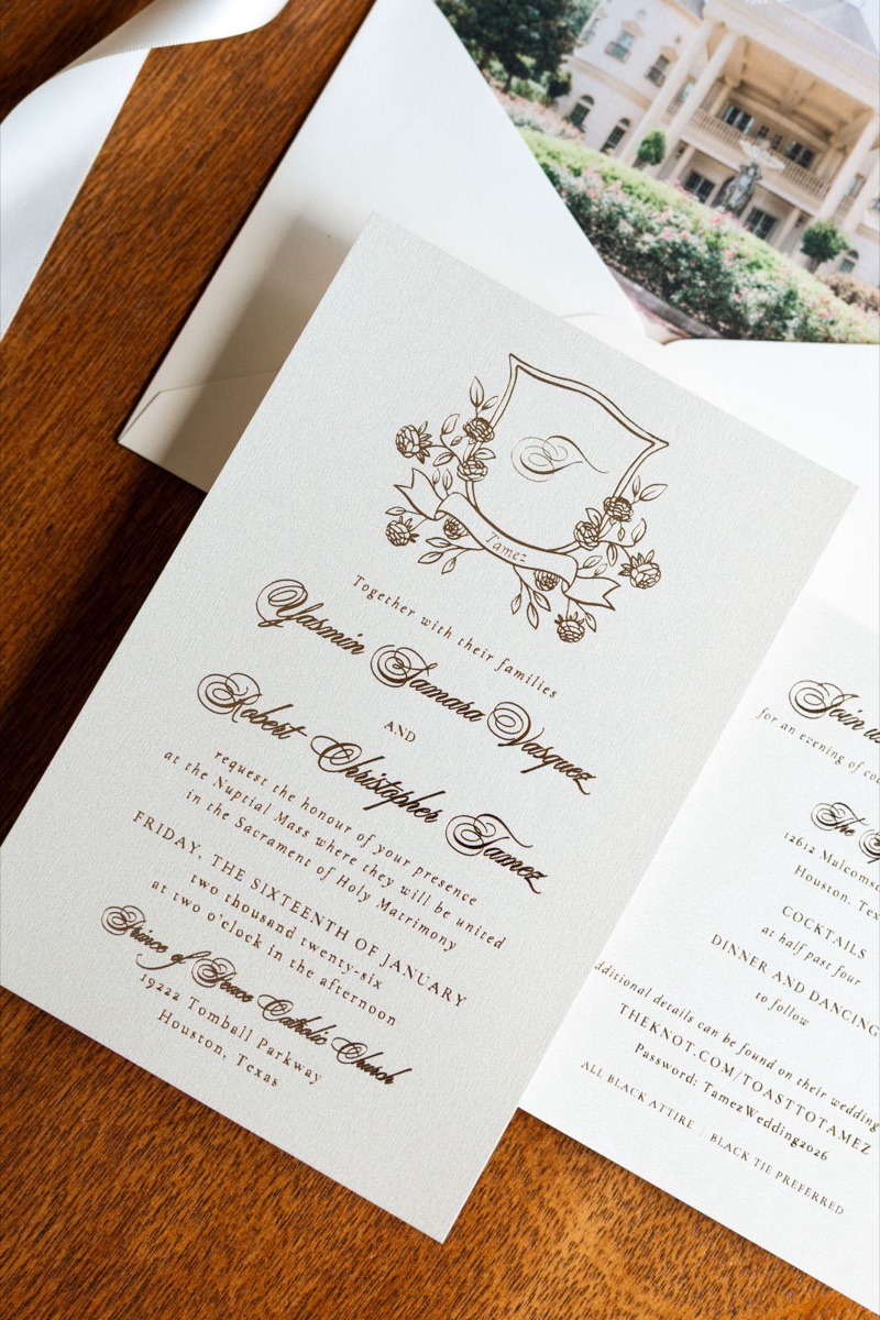 Invitation suite laid out with a crest and envelope