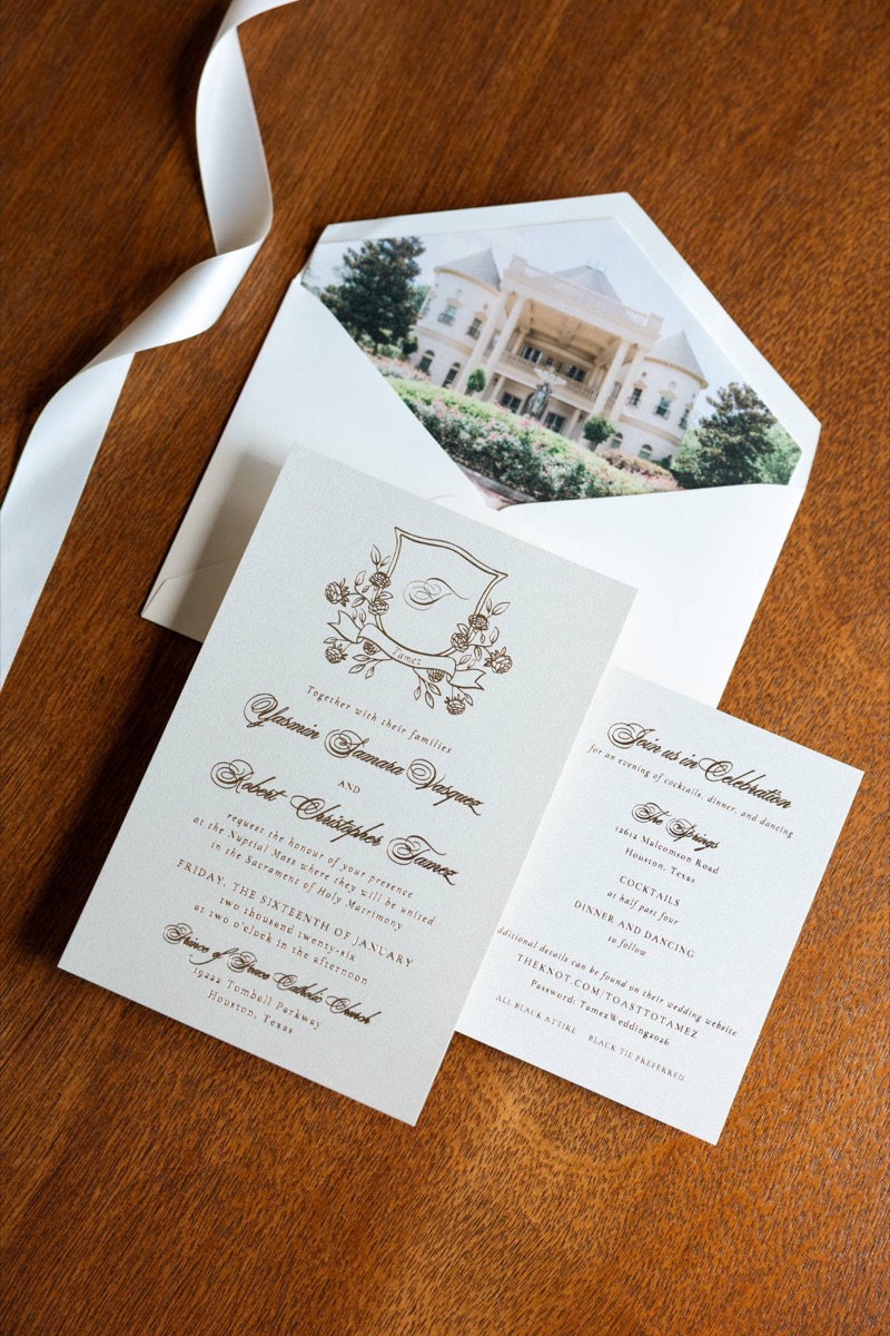 Invitation suite and details card on a wooden table