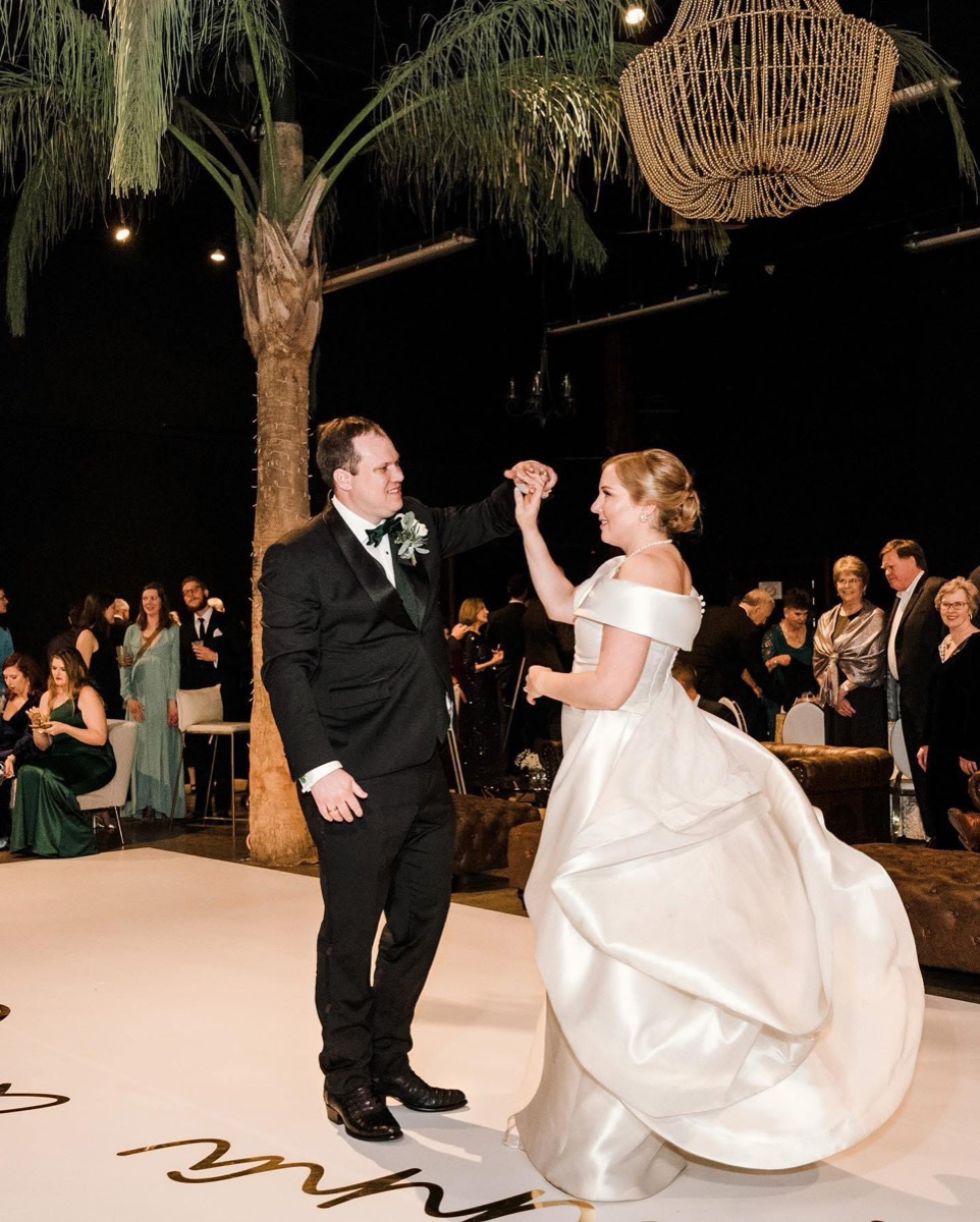 Couple dancing at a candlelit evening reception