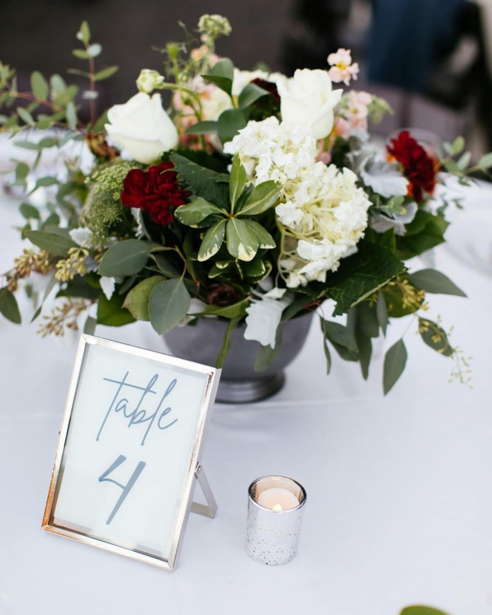 Floral centerpiece with a table number card